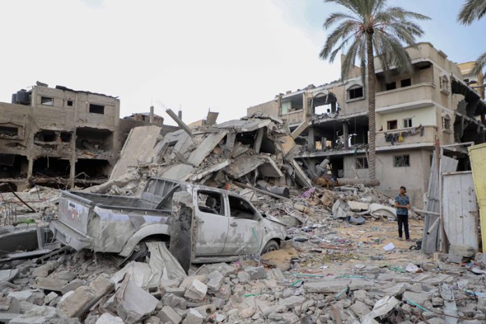 A man stands among the rubble of buildings destroyed in Israeli airstrikes in the southern Gaza Strip city of Khan Younis.