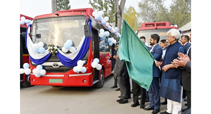 LG Manoj Sinha along with officials flagging off the fleet of new buses under the Srinagar Smart City Project. - Excelsior/Shakeel