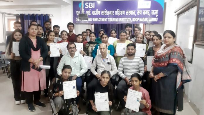 Candidates posing for a photograph with officials of SBI at Roop Nagar Jammu during the conclusion of training programme on Wednesday. Candidates posing for a photograph with officials of SBI at Roop Nagar Jammu during the conclusion of training programme on Wednesday.
