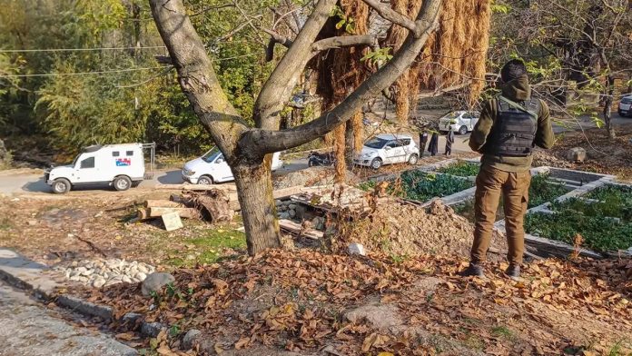 A security personnel stands guard during a raid conducted by Special Investigation Agency (SIA), in Anantnag district. SIA on Wednesday raided multiple locations in the Union Territory in a terror-related case.