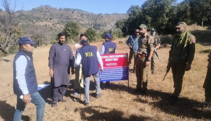 An NIA team attaching the land of terror operative at Balakote on Friday. —Excelsior/Rahi Kapoor