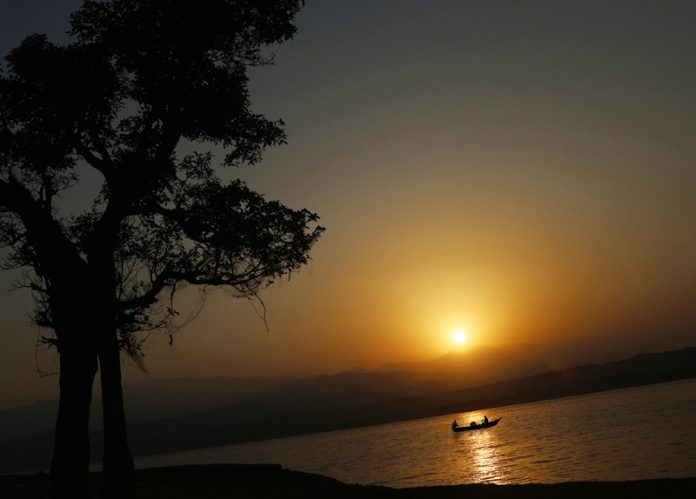 Fishermen heading to catch fish during Sunrise at river Ravi in Basohli area of Kathua. -Excelsior/Rakesh