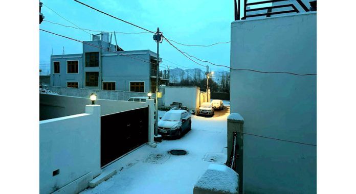 A view of season’s first snowfall in Leh town on Tuesday. (UNI)