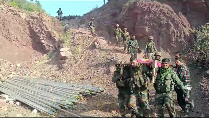 Troops shift injured on a bed from Bajimaal to hospital. -Excelsior/Imran