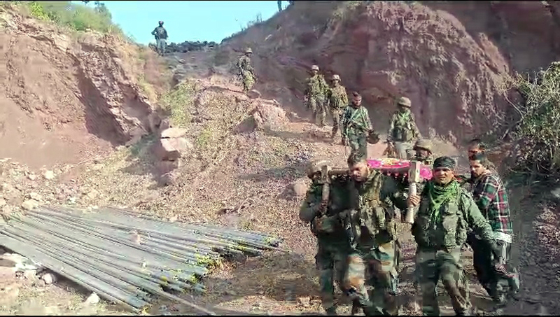 Troops shift injured on a bed from Bajimaal to hospital.-Excelsior/Imran