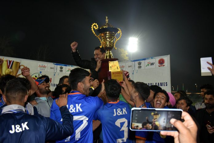 J&K Football team celebrating with winning trophy of National School Games.