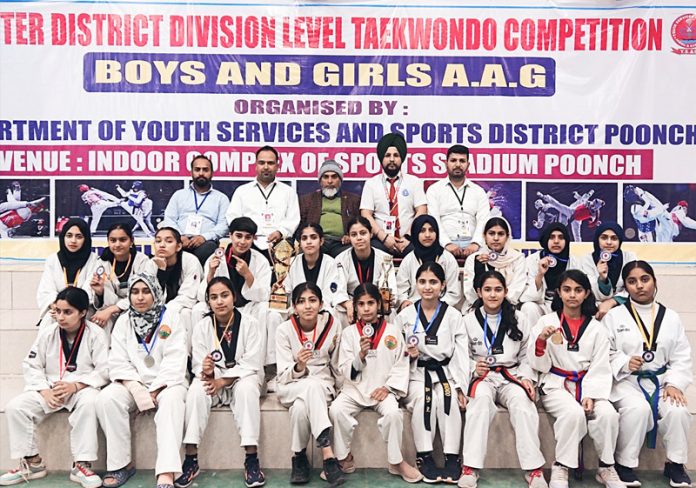 Poonch Taekwondo girls posing with the Trophy of Inter District Division level Taekwondo competition held at Poonch.