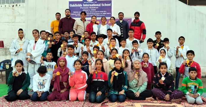 Judokas posing for group photograph during championship.