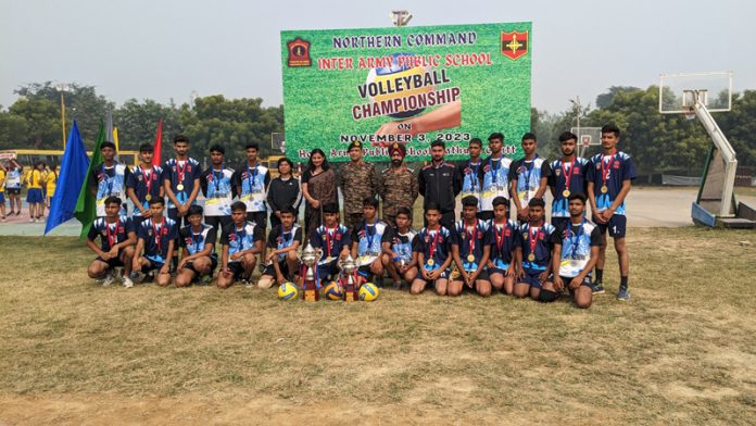 Victorious APS Akhnoor Volleyball team posing with trophy.