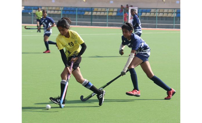 Girls in action during a hockey match at K K Hakku Stadium, Jammu on Saturday. —Excelsior/Rakesh Girls in action during a hockey match at K K Hakku Stadium, Jammu on Saturday. —Excelsior/Rakesh