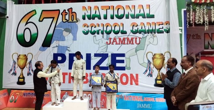 Players posing on podium with certificates and medals with dignitaries. Players posing on podium with certificates and medals with dignitaries.