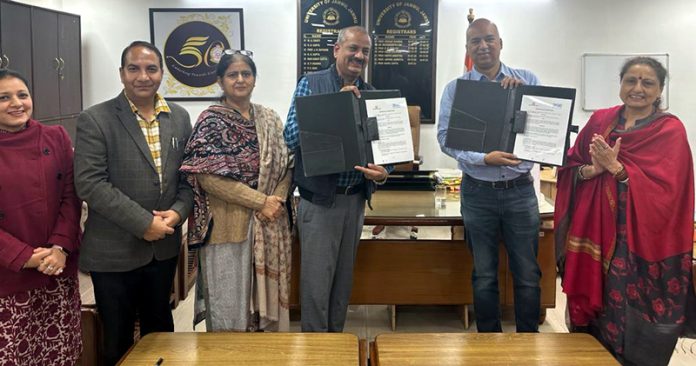 JU Registrar Prof Rahul Gupta and Akhil Chopra from BSE Institute Limited displaying copies of MoU.