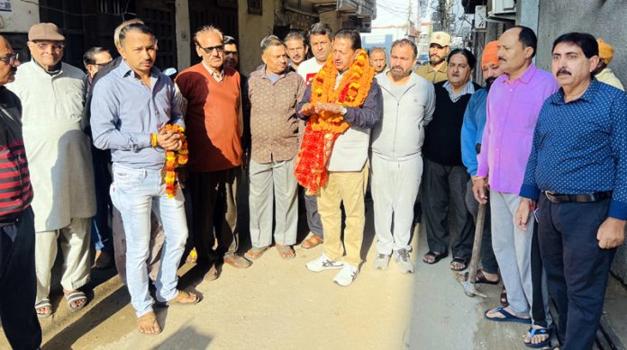 Dy Mayor, Baldev Singh Billawaria kick starting tile work of lane in Ward 42 on Monday.