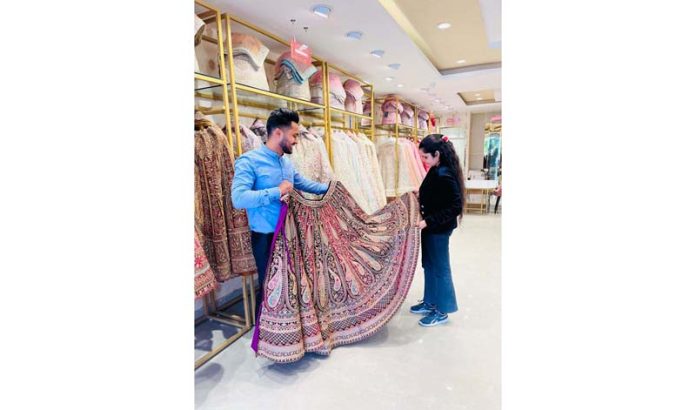 A customer selecting the outfits on the inaugurating day of Mohey Manyavar showroom in Jammu on Monday. A customer selecting the outfits on the inaugurating day of Mohey Manyavar showroom in Jammu on Monday.