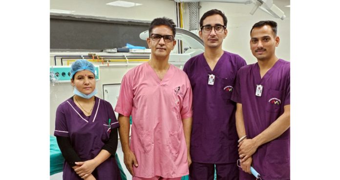 Interventional cardiologist Dr Syed Maqbool and his team posing together.