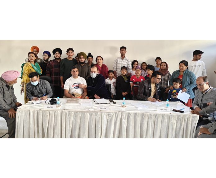 HoD Cardiology GMC Jammu Dr Sushil Sharma examining patients at a medical camp in Jammu on Sunday.