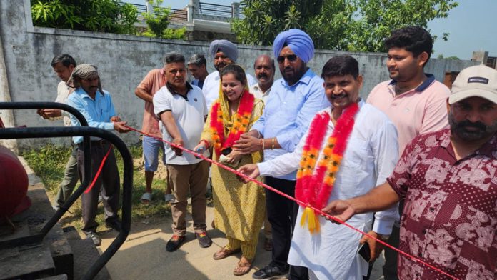 Congress leader Taranjit Singh Tony inaugurating road blacktopping work in Suchetgarh.