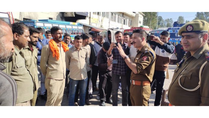 Police warns drivers of passenger vehicles against rash driving and overloading during interaction at Reasi on Friday.