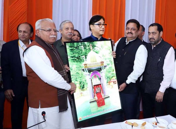 Kiran Wattal presenting LED pratima to Haryana CM Manohar Lal Khattar on Monday.