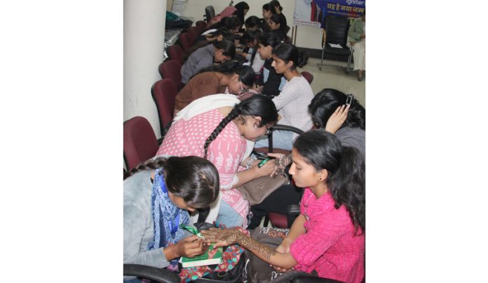 Candidates displaying their skill in ‘Mehandi’ competition. —Excelsior/Rakesh