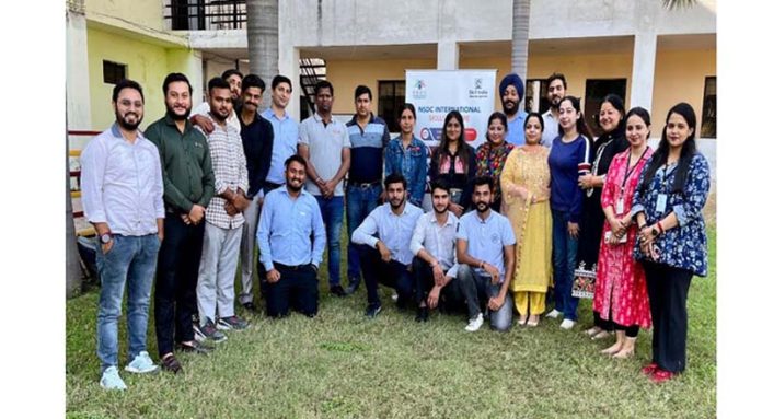 Candidates posing for a group photograph after their selection during a recruitment drive in Kunjwani.