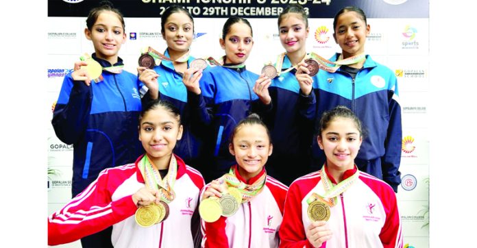 J&K Gymnastics team posing with medals. J&K Gymnastics team posing with medals.