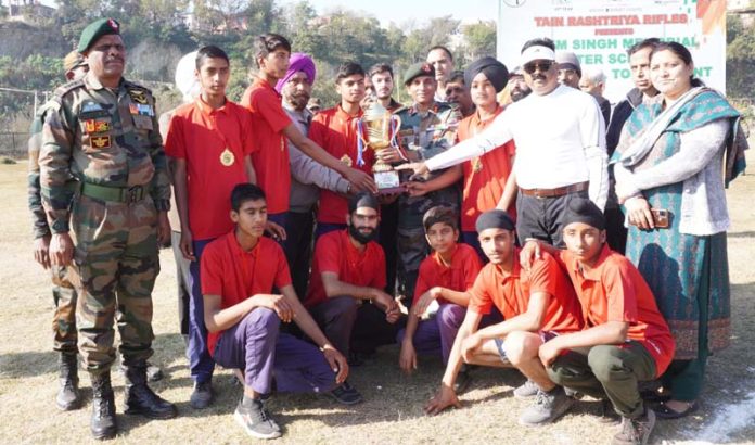 Volleyball team posing with Army officers and school management on Tuesday.