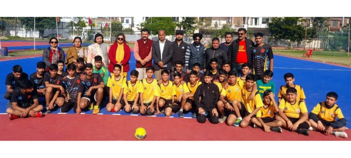 Dignitaries posing for group photograph with players during selection trials of competitions.