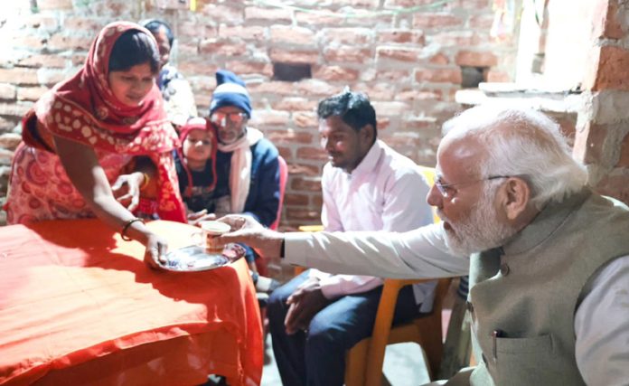 PM Narendra Modi taking tea at the residence of a Dalit woman in Ayodhya. PM Narendra Modi taking tea at the residence of a Dalit woman in Ayodhya.