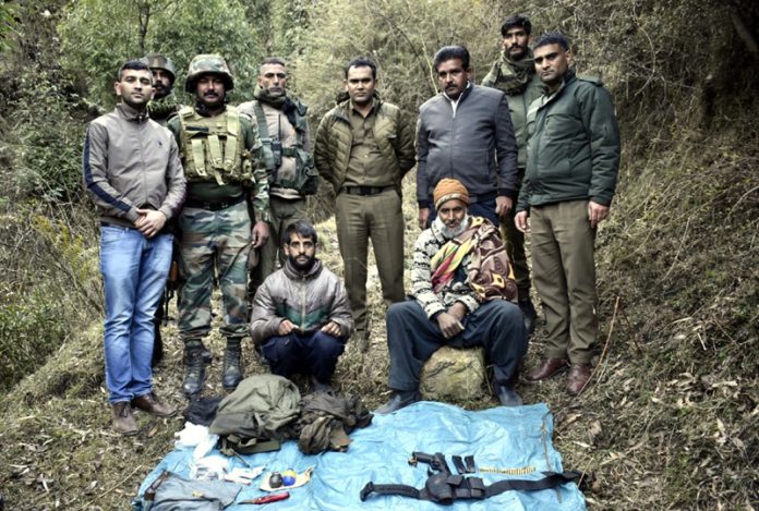 Two terror associates in custody of security forces along with arms and ammunition in Rajouri on Wednesday. -Excelsior/Imran