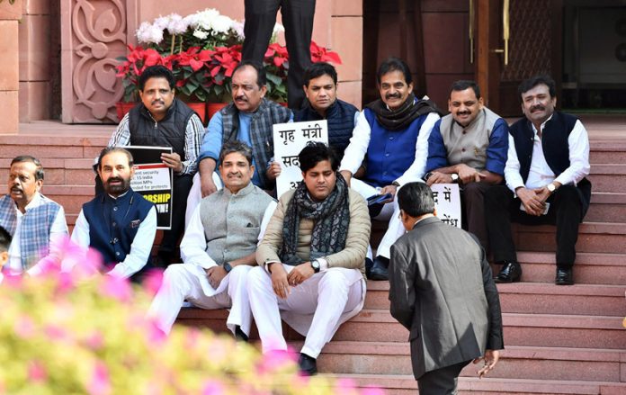 Suspended MPs sitting on a dharna at the stairs of Makar Dwar at Parliament House, in New Delhi on Monday.(UNI) Suspended MPs sitting on a dharna at the stairs of Makar Dwar at Parliament House, in New Delhi on Monday.(UNI)