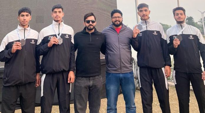 Jammu & Kashmir rowing team posing with medals.