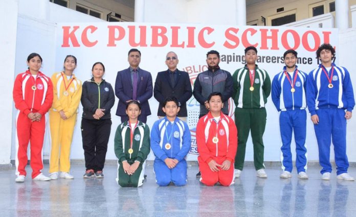 Seven swimmers of KC Public School posing with School management.