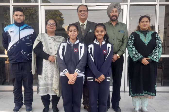 Tevishi and Samaira posing with school management.