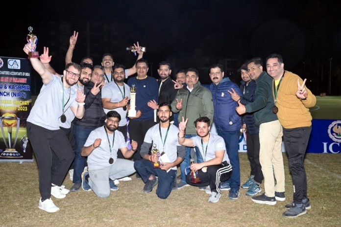 Team Grey posing with winning trophy during finals of Super Sixes Cricket tourney at Jammu.