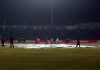 Ground staff covering pitch of Maulana Azad Stadium in Jammu on Thursday after rain. -Excelsior/Rakesh