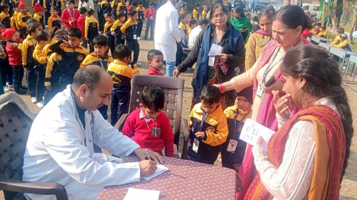 A doctor examines patients at a camp at Marh.