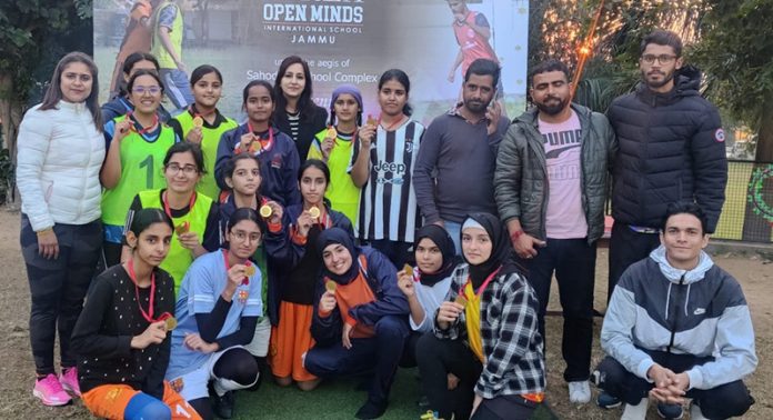 Football players posing with medals during Inter School Football Tourney.