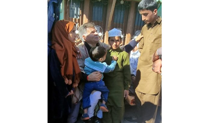 BJP president, Ravinder Raina consoling the families of victims at Topi Peer in Poonch on Friday.