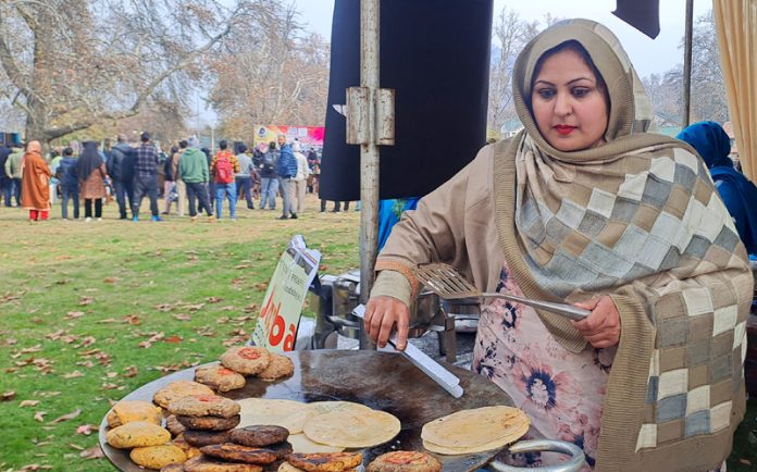 Batool preparing delicacies at a stall installed in Srinagar. — Excelsior/Shakeel Batool preparing delicacies at a stall installed in Srinagar. — Excelsior/Shakeel