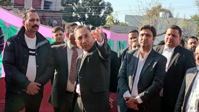 Justice Tashi Rabstan passing directions to an officer of Housing Board during visit to under-construction New Court Complex, Katra.