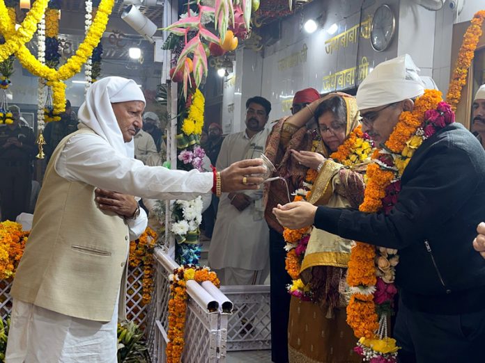 Mahant of Baba Ballo Devsthan offering Prasad to Atal Dulloo and his wife.