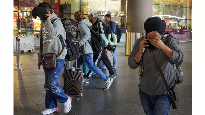 Passengers of a charter plane, which was grounded in France for four days over suspected human trafficking, arrive in Mumbai.