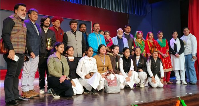 Guests and other dignitaries posing with artists during Festival of Duggar Folk Culture at Jammu.
