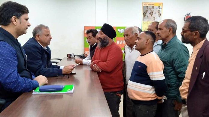BJP senior leader and former MLA Ashwani Sharma and party's convener Health and Medical Cell, Puneet Mahajan listening public grievances at Jammu on Saturday.