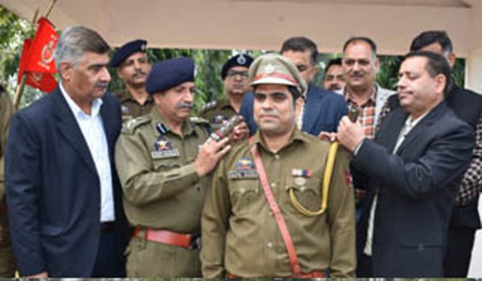 Principal PTTI Vijaypur, Shiv Kumar, pinning rank to a newly promoted officer at PTTI Vijaypur on Monday.