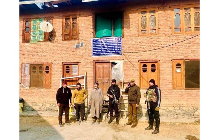Anantnag police attaching the property of terrorist associate in Kokernag on Thursday. (UNI)