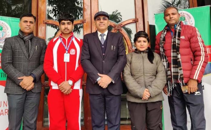 Hitesh Badyal, a student of K C Public School posing with School Management on Tuesday.
