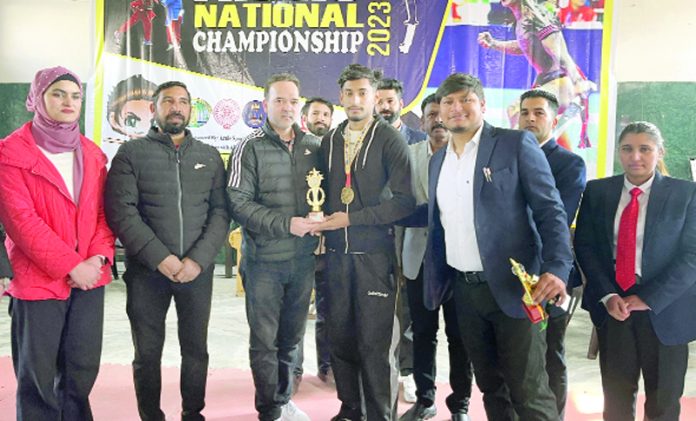 Bobbey Pandey receiving trophy from dignitaries.