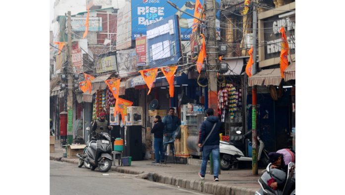 Saffron flags containing pictures of Lord Rama at shops in a market of Jammu on Sunday. -Excelsior/Rakesh